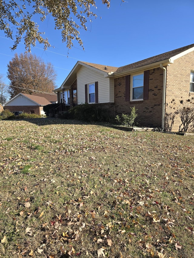 view of side of property with a yard