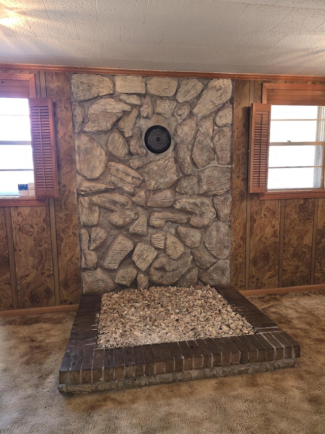 interior details with wooden walls, carpet, and a textured ceiling