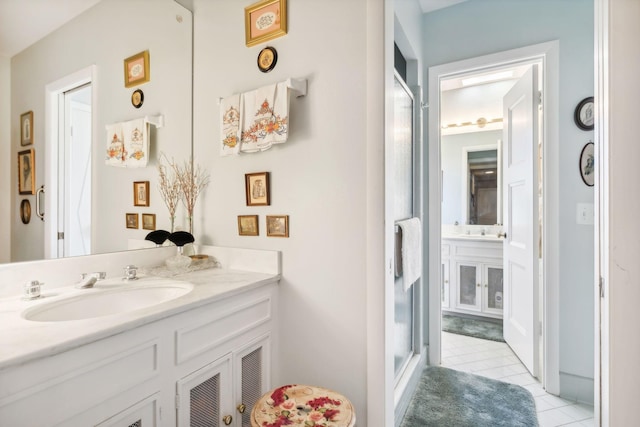 bathroom featuring tile patterned floors, vanity, and walk in shower