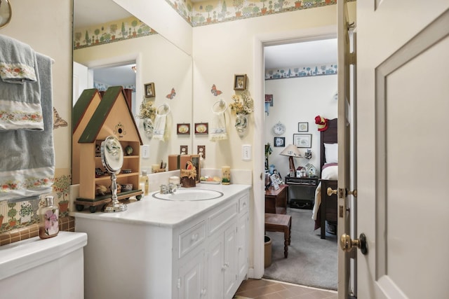 bathroom featuring tile patterned flooring, vanity, and toilet