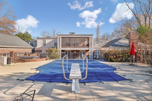 view of pool featuring a patio area and a sunroom