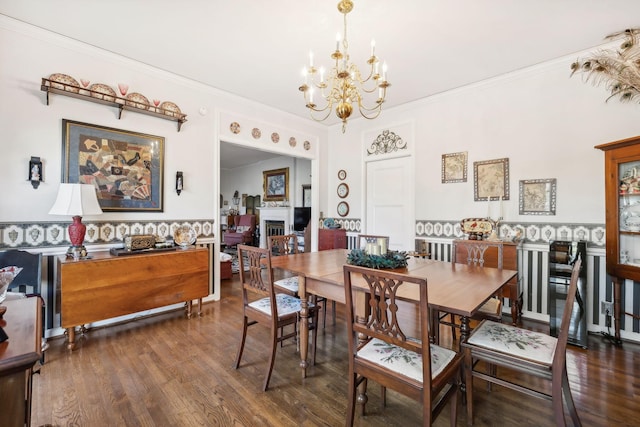 dining area featuring a chandelier, dark hardwood / wood-style floors, and ornamental molding