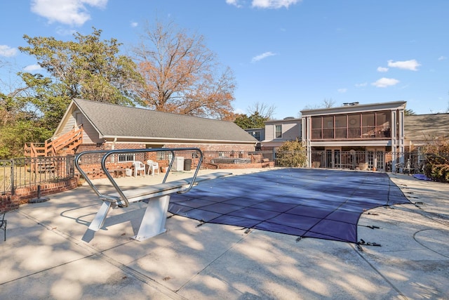 view of pool with a patio area and a sunroom