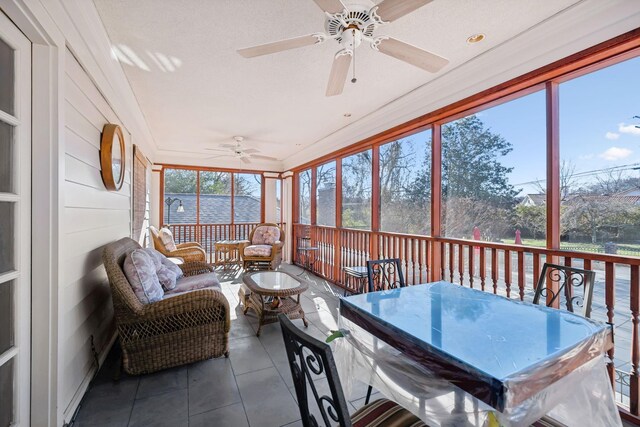 sunroom / solarium featuring ceiling fan