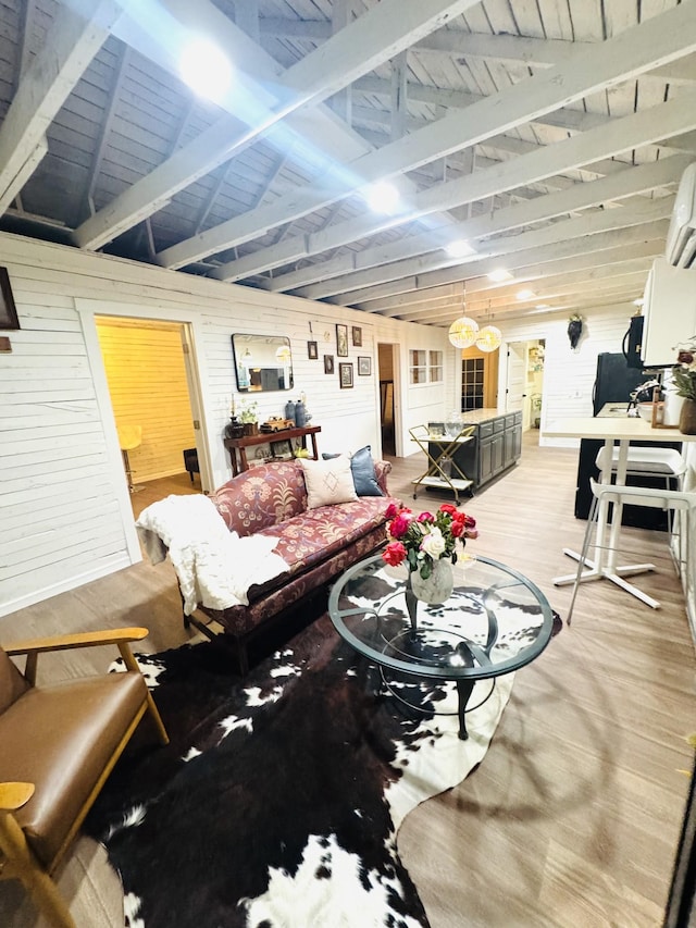 living room with hardwood / wood-style floors, wooden walls, and vaulted ceiling with beams