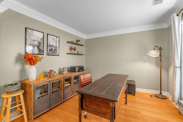 home office with light hardwood / wood-style flooring and ornamental molding