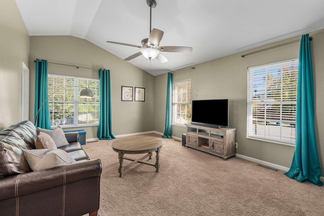 carpeted living room with ceiling fan and lofted ceiling