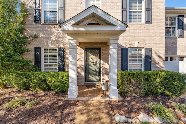 view of exterior entry featuring a garage