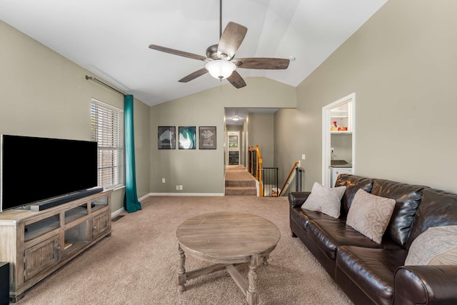 carpeted living room featuring ceiling fan and vaulted ceiling