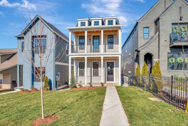 view of front of property with covered porch, a balcony, and a front lawn