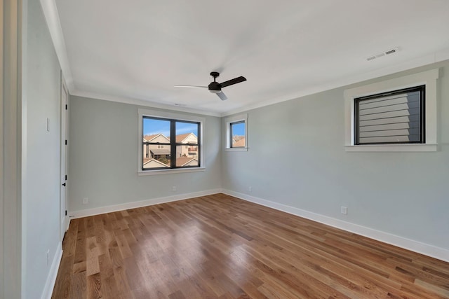 unfurnished room with ceiling fan, crown molding, and hardwood / wood-style floors