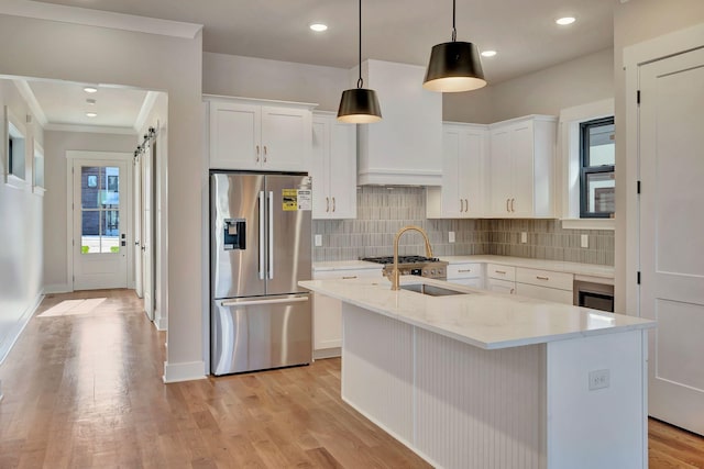 kitchen with white cabinets, a barn door, stainless steel fridge with ice dispenser, and pendant lighting