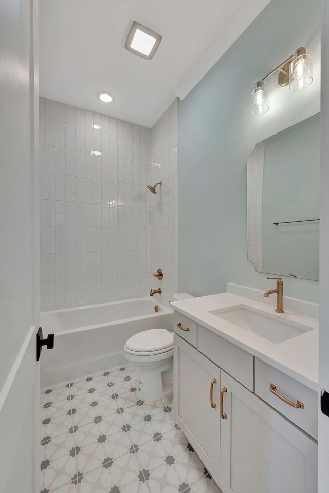 full bathroom with toilet, vanity, and tiled shower / bath