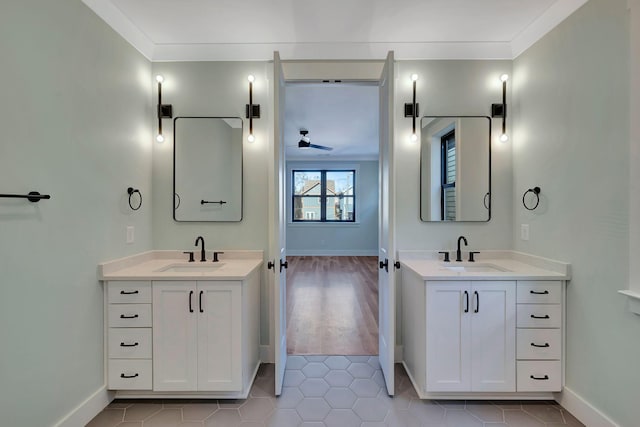 bathroom with ceiling fan, tile patterned flooring, crown molding, and vanity