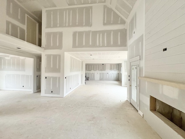 unfurnished living room with a high ceiling