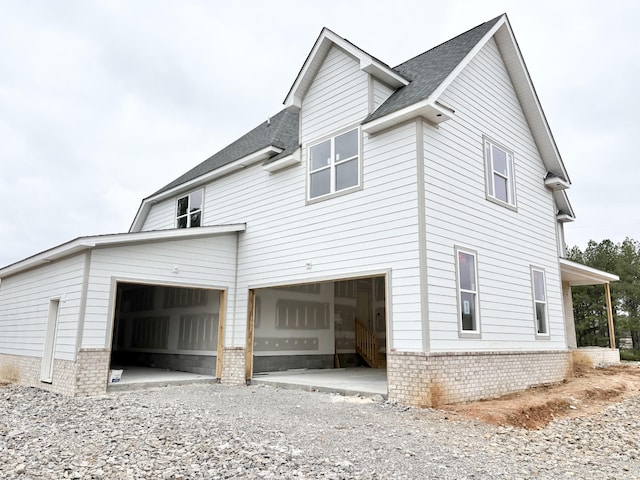 view of side of home featuring a garage