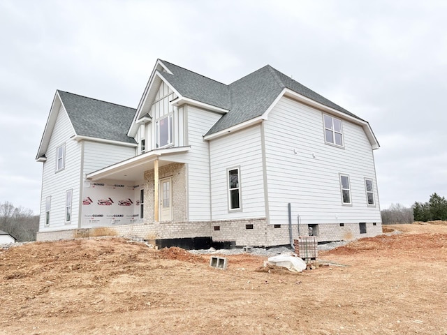 view of side of home featuring covered porch