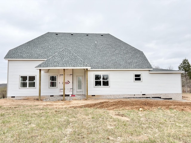 rear view of property with a lawn