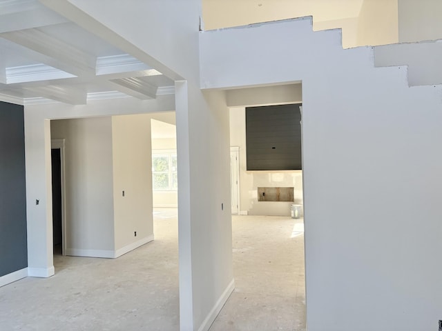 hall with baseboards, coffered ceiling, beamed ceiling, and ornamental molding