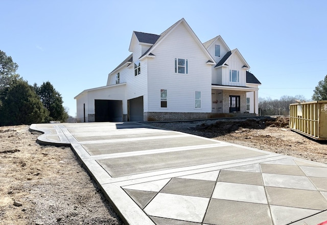 modern farmhouse featuring a garage and driveway