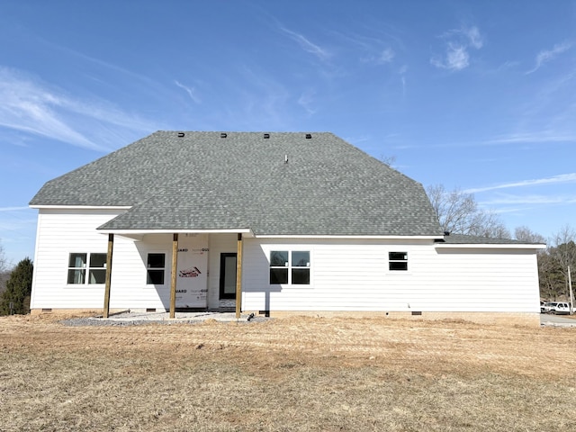 back of house with crawl space and roof with shingles