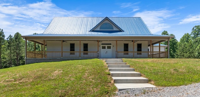 farmhouse with covered porch, ceiling fan, and a front yard