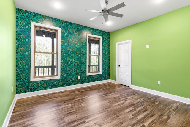 spare room featuring wood-type flooring and ceiling fan