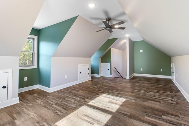 additional living space featuring dark hardwood / wood-style floors, ceiling fan, and lofted ceiling