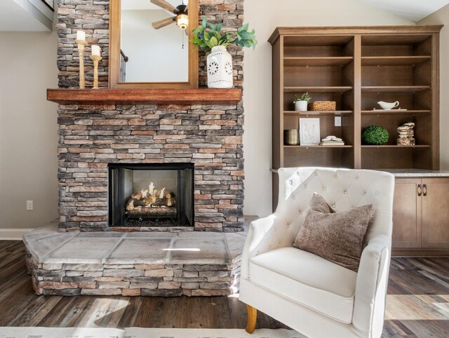 living area with a fireplace, hardwood / wood-style floors, and lofted ceiling