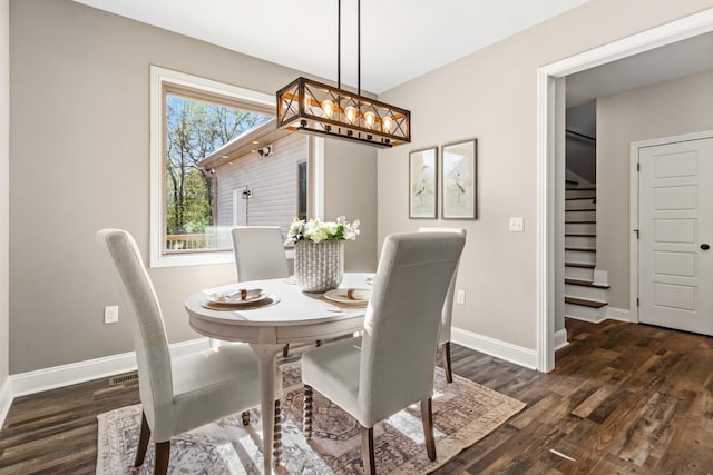 dining area featuring a notable chandelier and dark hardwood / wood-style floors