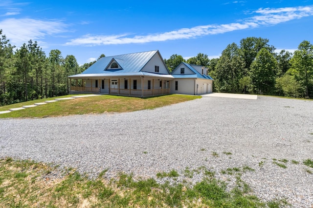 country-style home with covered porch and a front lawn