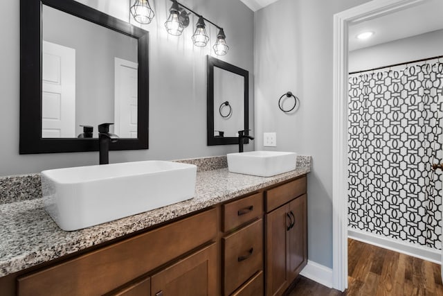 bathroom featuring hardwood / wood-style floors, vanity, and curtained shower