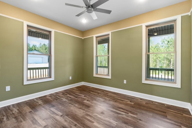 unfurnished room with dark hardwood / wood-style floors, a healthy amount of sunlight, and ceiling fan