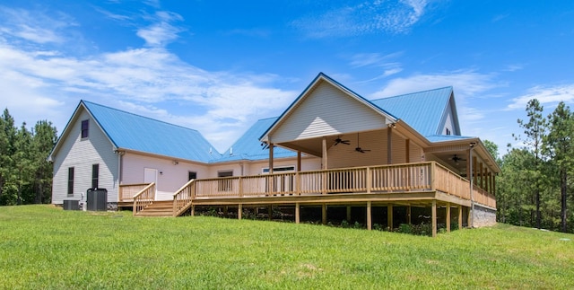 back of property with ceiling fan, a yard, a wooden deck, and central AC