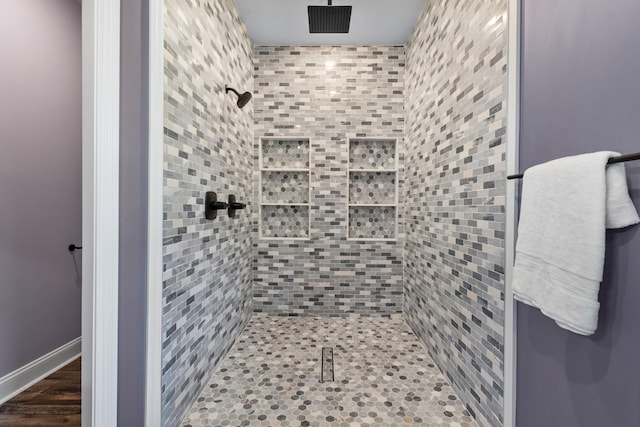 bathroom featuring hardwood / wood-style floors and a shower with shower door