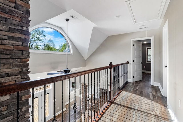 hallway with dark hardwood / wood-style flooring and vaulted ceiling