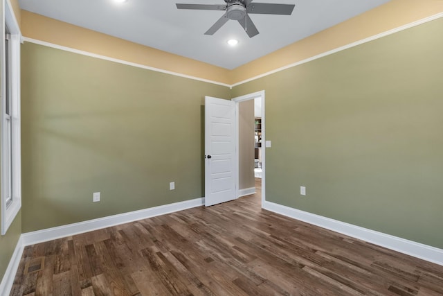 spare room with ceiling fan and dark hardwood / wood-style floors