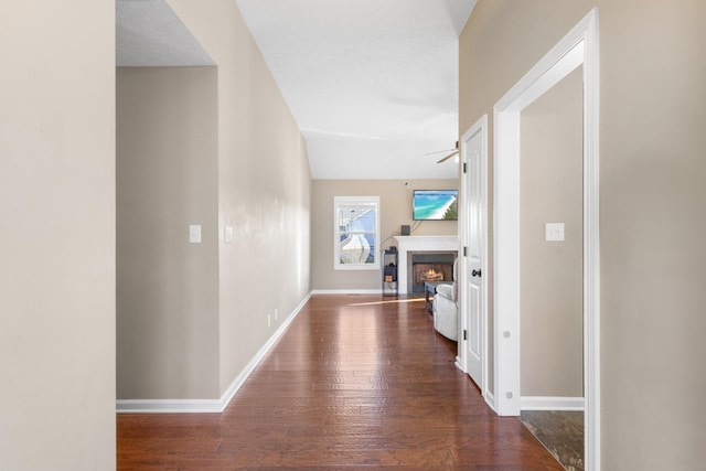 corridor with dark hardwood / wood-style flooring