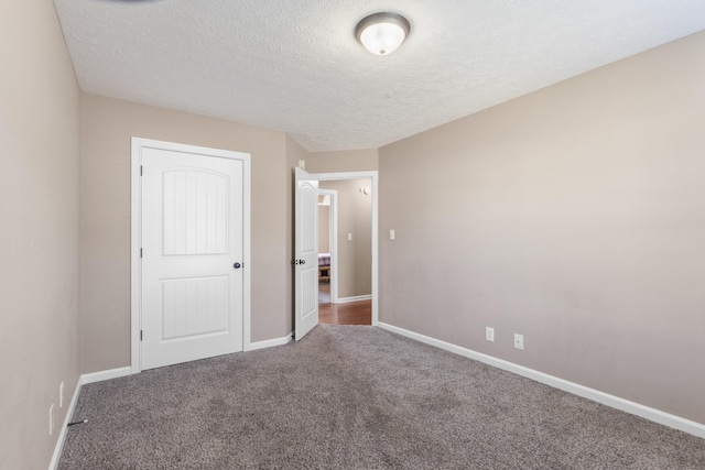 unfurnished bedroom with carpet flooring, a closet, and a textured ceiling