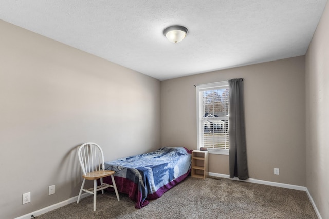 carpeted bedroom featuring a textured ceiling