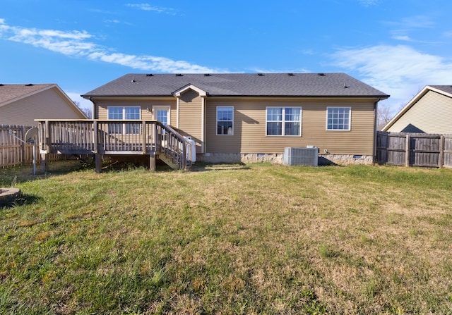 back of house with a lawn, a wooden deck, and cooling unit