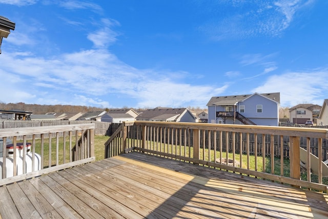 wooden terrace featuring a lawn