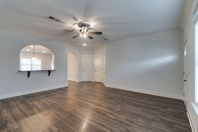 empty room with ceiling fan, dark hardwood / wood-style flooring, and crown molding