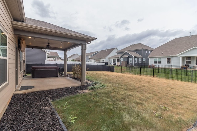 view of yard with ceiling fan, a patio, and a hot tub