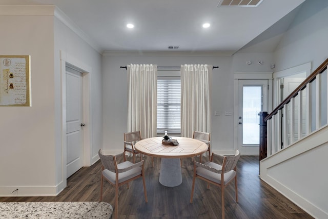 dining space with dark hardwood / wood-style floors and ornamental molding