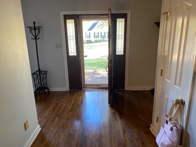 entryway with dark wood-type flooring