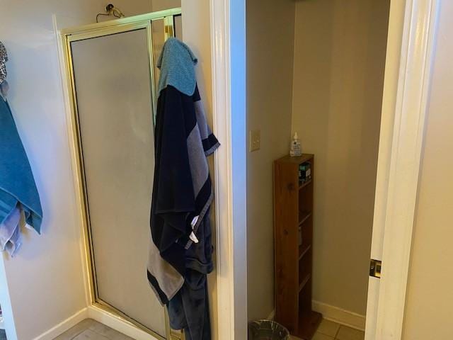 bathroom with tile patterned flooring and an enclosed shower