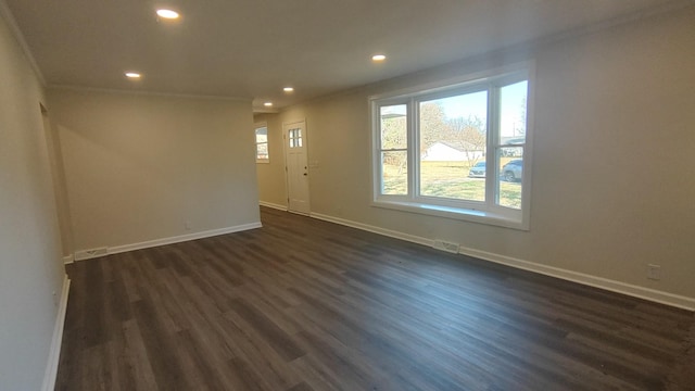 unfurnished room with ornamental molding and dark wood-type flooring