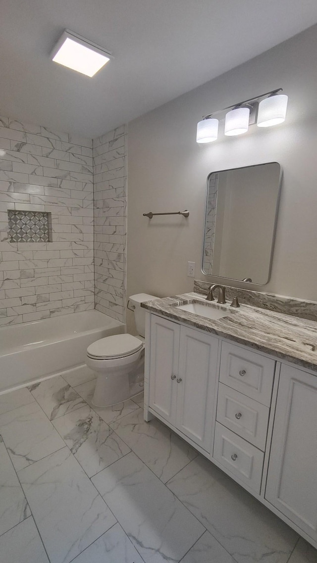 full bathroom featuring vanity, toilet, and tiled shower / bath