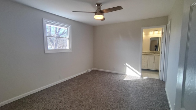 empty room featuring ceiling fan and light colored carpet